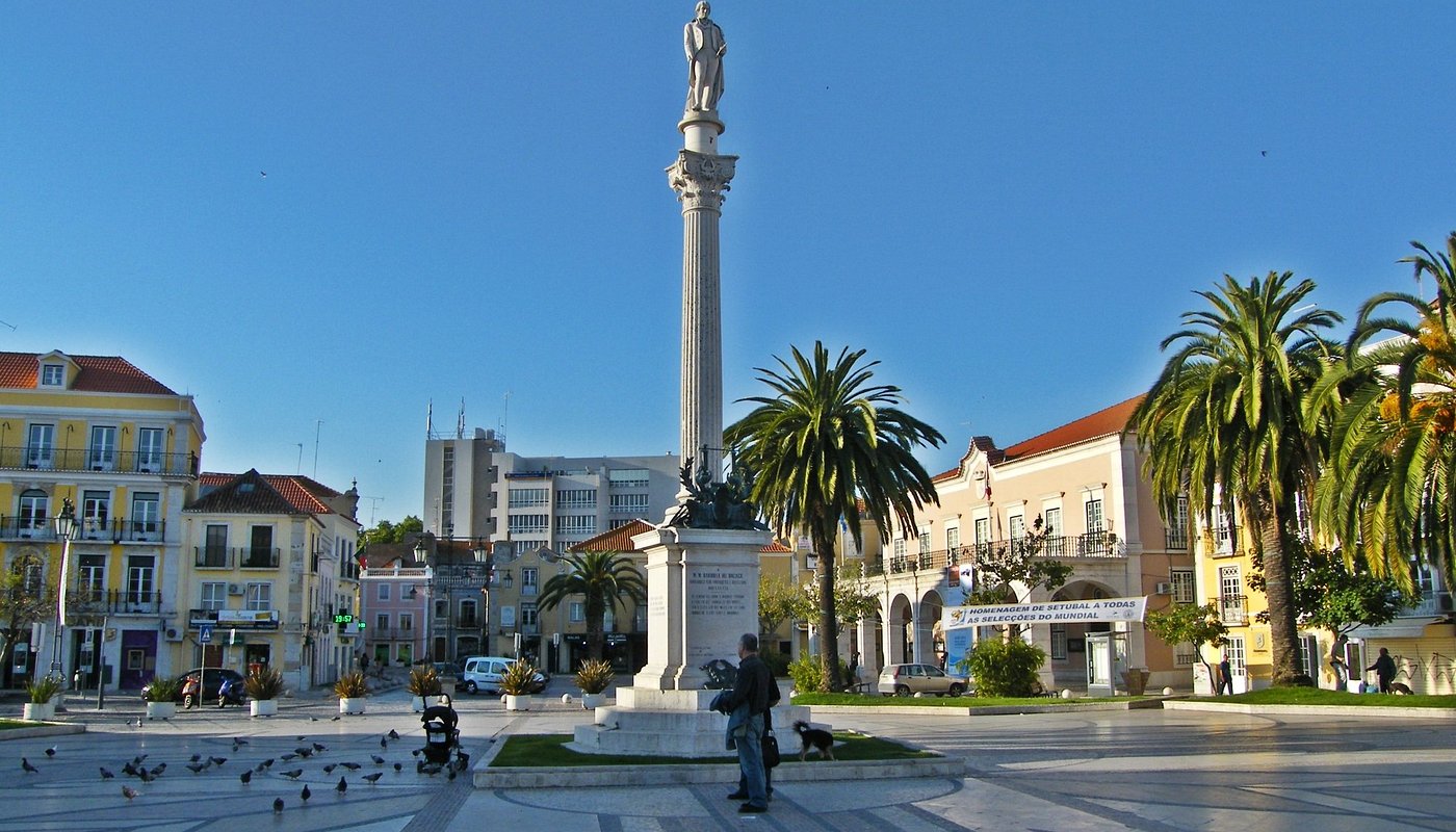 A famous plaza, Praça do Bocage in the city center of Setúbal, Portugal. It contains a statue of the poet, Bocage and is surrounded by benches, restaurants and cafes.